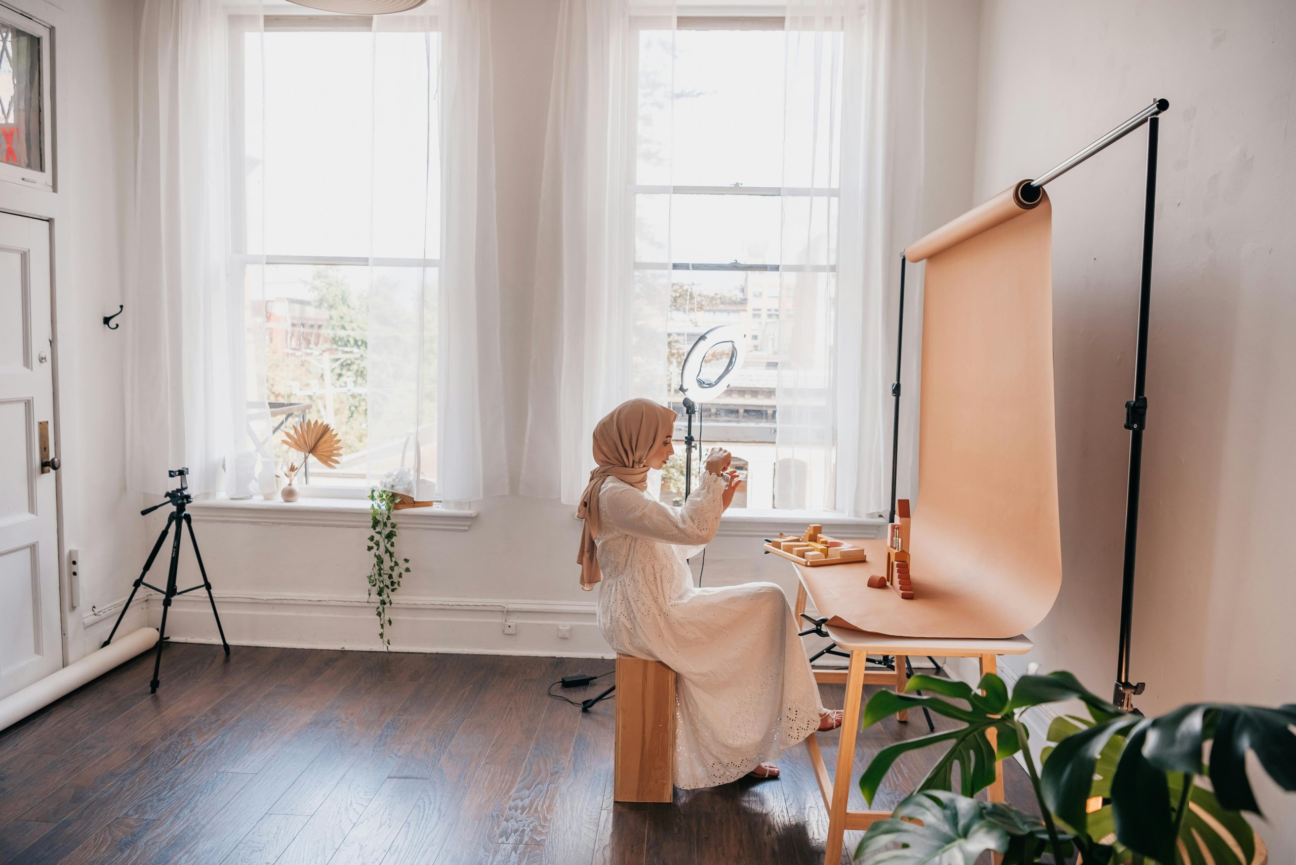 A Young Woman Taking Photographs in her Studio